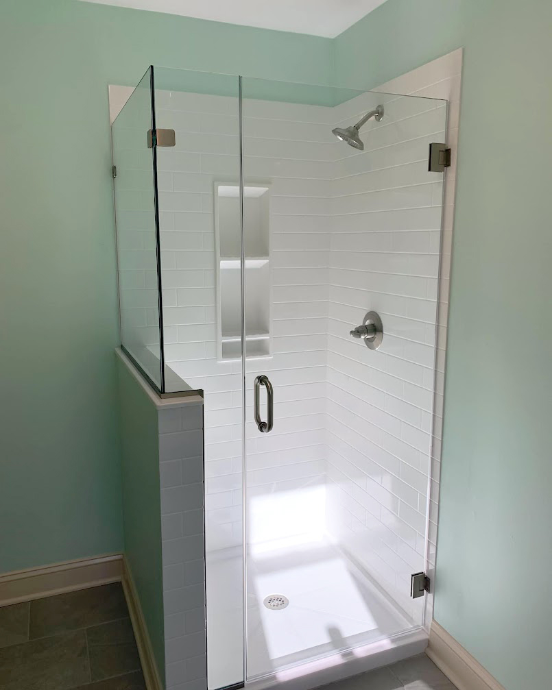Walk-in shower remodel with frameless glass door and solid-surface walls installed by AZ Fast Bath in the East Valley, Arizona.